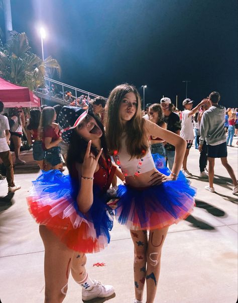 cute west football game outfits usa USA united states foot ball game theme themed aesthetic duo outfit duo outfits two person outfit tutu tank top shorts poses vsco 2 people poses leg paint red white and blue night photos Usa Theme Game, Usa Game Day Outfit, Superhero Fnl Theme, Things To Wear To A Football Game, American Day Spirit Week, Fourth Of July Spirit Week, Usa Halloween Costume, Superhero Football Theme Outfit, Outfits To Wear To Football Games