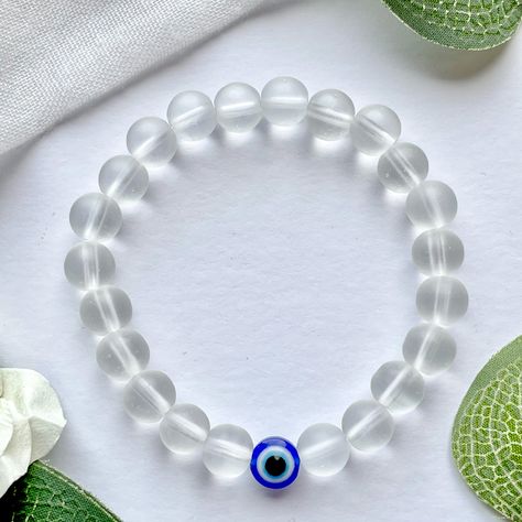 No Nazar Collection - Clear
Handmade clear bead bracelet with one evil eye bead.

The evil eye is regarded as a symbol of protection. It is believed that by wearing the evil eye, its watchful gaze will ward off evil spirits by protecting you against any negative energy, jealousy and harm.
Perfect as a gift or as a treat for yourself. Evil Eye Bracelet Ideas, Etsy Beaded Bracelets, Pulseras Kandi, Homemade Stuff, Turkish Evil Eye, Beads Bracelet Design, Men Bracelet, Bracelet Design, Women Bracelet