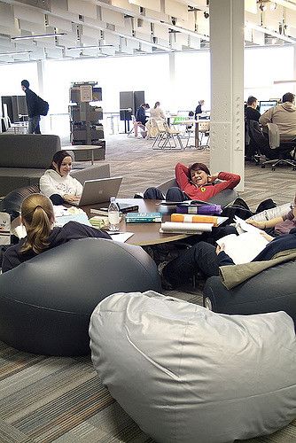 Beanbags provide a relaxed setting for study.  Staff have flexible use of the space by temporarily removing the beanbags during the run up to exams to quieten the area. Office Inspiration Workspaces, Bean Bag Lounge, Bean Bag Office, Student Lounge, Startup Office, Study Cafe, Creative Office Space, Corporate Office Design, Office Lounge