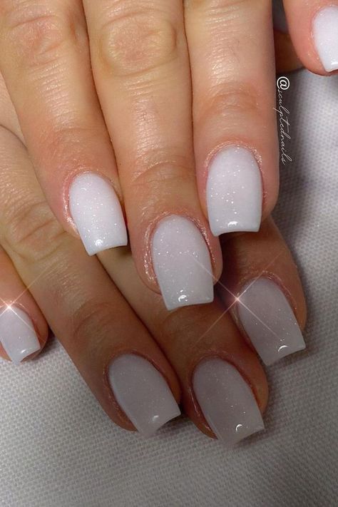 Elegant and understated, these white glitter nails are a vision of subtle sparkle. The almond shape offers sophistication, while the white base is elevated with a dusting of fine glitter that catches the light, reminiscent of a gentle snowfall. Perfect for any occasion that calls for a touch of refined glamor. ✨  // Photo Credit: Instagram @sculptednails Cute Bridesmaids Nails, Short Acrylic Nails Square White Sparkle, Shimmering White Nails, Bride Nails Bachelorette, Dip Bride Nails, Pearly White Wedding Nails, Nails White Sparkle Glitter, White Shimmer Gel Nails, White Glitter Manicure