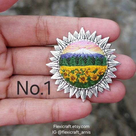 Landscape embroidered brooch, scenery hand embroidery pins, sunflower, lake, mountain Brooch size 1.25 inch Buy from my Etsy shop: flexicraft.etsy.com Full collections and tutorials Instagram.com/flexicraft_arnis Scenery Embroidery, Embroidery Pins, Embroidery Landscape, Embroidered Brooch, Landscape Mountain, Lake Mountain, Hand Embroidery Design, Embroidery Design, Hand Embroidered