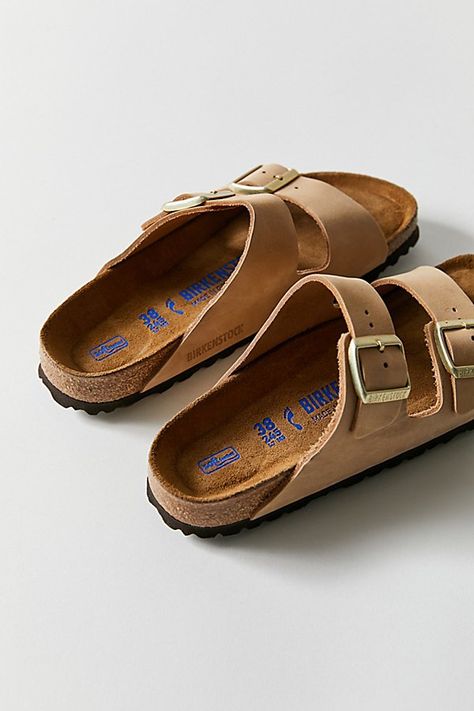 The legendary two-strap design from Birkenstock. The Arizona combines iconic style with signature comfort, featuring an additional soft layer in the anatomically formed footbed with integrated latex foam cushion. Nubuck leather upper with individually adjustable metal pin buckles. Content + Care Leather, cork, EVA Spot clean Imported Size + Fit True to size Medium/Narrow width | Birkenstock Arizona Soft Footbed Leather Sandal in Sandcastle Nubuck, Women's at Urban Outfitters Womens Birkenstocks Outfit, Arizona Birkenstock Outfit, Leather Birkenstocks, Womens Birkenstocks, Birkenstock Sandals Outfit, Shoe Goals, Birkenstock Outfits, Birkenstock Outfit, Birkenstock Sandals Arizona