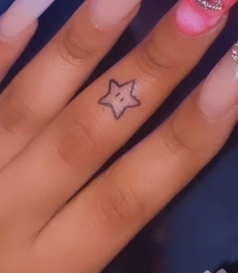 Mario Star Tattoo Small, Finger Tattoos For Women Black, Stick And Poke Tattoo Black Skin, Baddie First Tattoo Ideas, 1010 Tattoo Ideas, Coin Size Tattoo, Finger Tattoo Black Women, Small Tattoo Ideas Y2k, Tattoo Ideas On Black Women