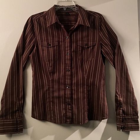 Express light weight brown stripped button up Express portofino button up. This shirt has two pockets in the front, hidden flaps inside which allow the shirt to be rolled up and buttoned into place (shown in pictures). It's light weight, 100% cotton. Tag sags medium. 🚫PayPal or trades. Reasonable offers will be considered. Please use the "offer" button - I don't negotiate in the comments. Express Tops Button Down Shirts Work Clothes, Striped Button Down, Striped Button Down Shirt Outfit, Y2k Button Up Shirt, Vintage Button Up Shirt, Thrift Inspo, Y2k Shirt, Cold Outfits, Button Up Shirt