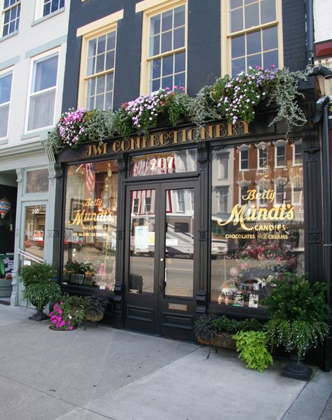 Old store front -- Madison, In.  Love the window boxes! Bakery Store Front Ideas, Storefront Planter Ideas, Business Window Decals Store Fronts, Main Street Store Fronts, Vintage Store Exterior, Retail Store Front Porch, Old Downtown Storefronts, Old Shop Fronts, Store Front Flowers