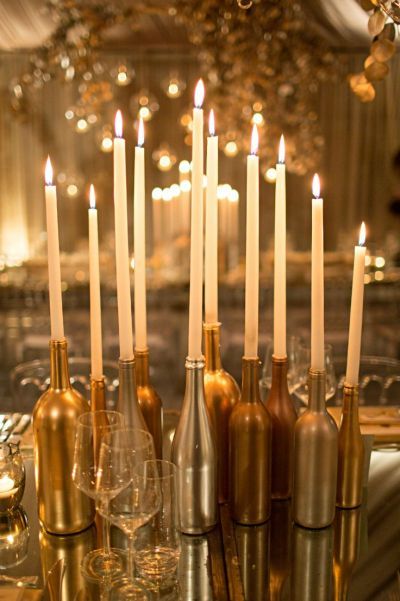 Candles placed in wine bottles is a golden 50th birthday decorating idea.  See more 50th birthday party themes and party ideas at www.one-stop-party-ideas.com