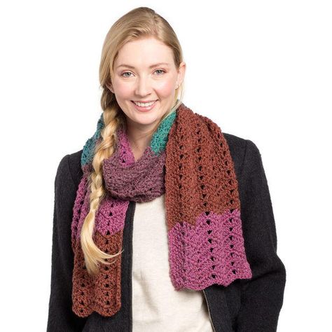 Tired of the same old boring scarves? Try the One Skein Caron Cakes Scarf on for size. Self-striping yarn patterns are the best way for beginner crocheters to add a pop of color without the effort of learning to carry and switch yarn colors while crocheting. This colorful scarf uses a repeated double crochet stitch pattern to create a warm winter accessory sure to get you a thousand compliments! The best thing about this scarf is that once you’ve got the pattern down to muscle memory, you can Crochet Waves, Caron Cakes Patterns, Caron Cakes Crochet, Caron Cakes, Infinity Scarf Pattern, Crochet Scarf Pattern Free, Crochet Infinity Scarf, Colorful Scarf, Double Crochet Stitch