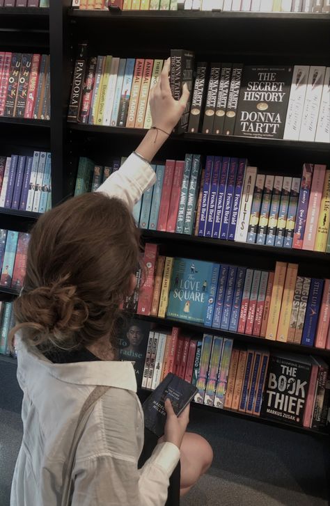 a girl sitting in front of a bookshelf in a bookstore and holding “the secret history“ by Donna Tartt Book Store Owner Aesthetic, Bookstore Worker Aesthetic, Publisher Aesthetic, Book Shopping Aesthetic, Cooper Aesthetic, Author Aesthetic, Buying Books, Joy Williams, Book Art Projects