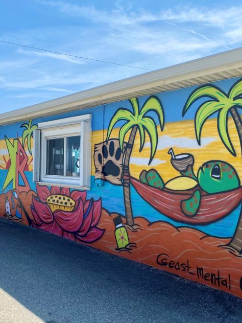 Restaurants and cafés across Flagler Beach have partnered with local artists to splash their exteriors with murals like the ice cream-themed mural at Surfside Shakes, and the Insta-worthy “Raining Donuts” mural outside Swillerbees Craft Donuts and Coffee Bar. Their close proximity makes it easy to complete a mural crawl in the heart of Flagler Beach and admire art while enjoying some of our best food and drinks. Check out this map to plan your walk. Beach Murals Outdoor, Summer Mural Ideas, Beach Mural Painted Wall, Poolside Mural, Beach Mural Painted, Mural Wall Art Outdoor, Outside Murals, Murales Bar, Turtle Mural