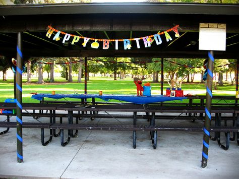 Outdoor party at a park pavilion, decorated using streamers, banner, and tablecloths in primary colors from the $store. Decorating A Pavilion For A Birthday, Park Pavilion Decorations Birthday, Party At A Park, Pavilion Decor, Picnic Table Decor, Cowboy Party Decorations, Western Party Decorations, Party At The Park, Backyard Kids Party