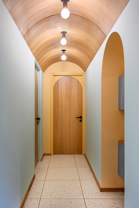 A Modern Kerala Apartment Full of Unexpected Colors and Curves Long Corridor Ideas Interior Design, Interior Design Indian, Arched Doorway, Wooden Ceiling Design, Midcentury Interior, Corridor Design, Arched Headboard, Small House Interior Design, Unique Light Fixtures