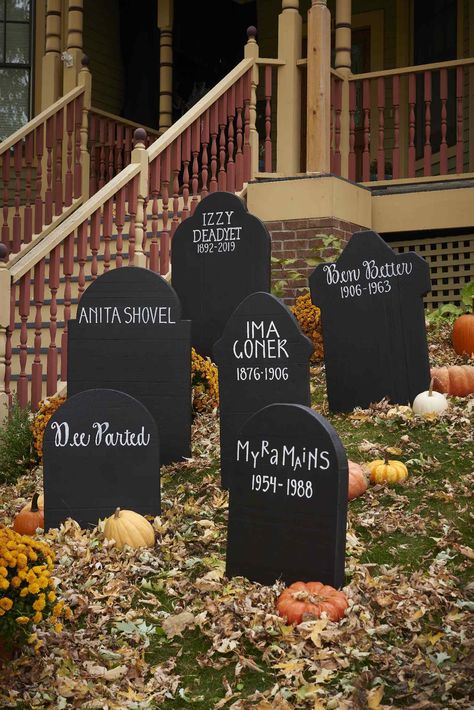 These simple DIY Halloween tombstones require a white paint pen, black paint, and a little inspiration.  #halloween #halloweenideas #diyideas #halloweendiy #bhg Tombstones Diy Halloween, Tombstone Decorations Halloween, Fake Tombstones Diy, Diy Tombstones Halloween Foam, Diy Grave Stones Halloween, Diy Wooden Tombstones Halloween, Fake Graveyard Halloween, Tombstone Ideas Halloween, Wood Tombstones For Halloween
