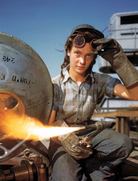 Pretty girl adjusts goggles while holding flaming welding torch Women Welder, Perang Dunia Ii, Margaret Hamilton, Electric Boat, Rosie The Riveter, Young Female, Pearl Harbor, Historical Pictures, Photos Of Women