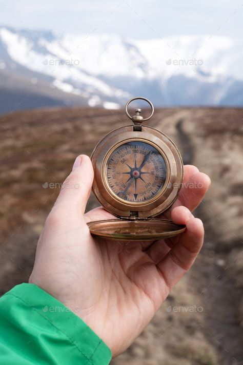 Man with retro compass in hand by ivankmit. Man with retro compass in hand in high mountains. Travel concept. Landscape photography #AD #hand, #ivankmit, #compass, #Man Compass Aesthetic, Compass Picture, Compass Photography, Concept Landscape, Inktober 2023, Compass Jewelry, Vintage Compass, Mountains Travel, True North