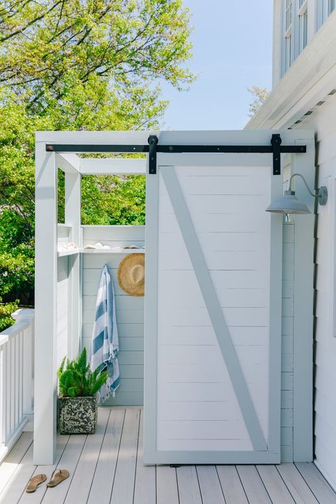 an outdoor shower with a sliding barn door Beach House Outdoor Shower Ideas, Outdoor Shower Ideas Backyards, Diy Outdoor Shower Ideas, Showers Design, Outdoor Shower Ideas, Beach House Outdoor, Outdoor Pool Shower, Portable Outdoor Shower, Outdoor Shower Enclosure