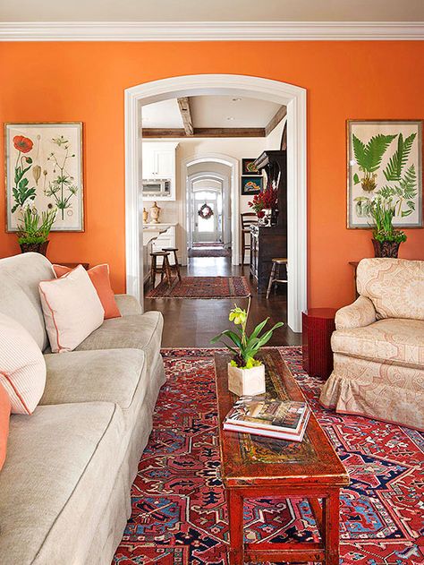 Even traditionally minded decor can benefit from a jolt of unexpected wall color. Here, a bright spice orange infuses a classic living room with energy. The color is used in small doses throughout the room so the wall color doesn't appear as an afterthought. The Color: Bryce Canyon -- Benjamin Moore Orange Wallpaper Living Room, Unique Paint Colors, Orange Paint Colors, Orange Rooms, Happy Room, Living Room Orange, Orange Decor, Orange Paint, Orange Walls
