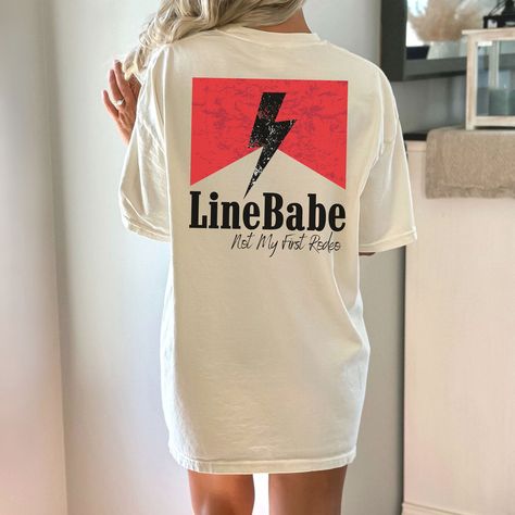 "Introducing our Line Babe Shirt, specially designed for the Lineman Rodeo, where classic country western style meets heartfelt appreciation for the Lineman community. Crafted with precision and passion, this shirt celebrates the unyielding strength and unwavering support that Lineman's Wives provide every day. The design speaks volumes with the words \"Line Wife\" elegantly emblazoned, showcasing your dedication to your Lineman and the honorable profession they uphold. The vintage touch adds an authentic charm, connecting you to the roots of this revered tradition. And there's a playful twist too! The phrase \"Not my first rodeo\" graces the shirt, humorously reminding everyone of the countless challenges you've conquered together. It's a conversation starter that brings smiles and camara San Jose, Air Force Wife Shirt, Lineman Shirts, Lineman Wife, Lineman Gifts, Airforce Wife, Air Force Shirt, Babe Shirt, Military Wife