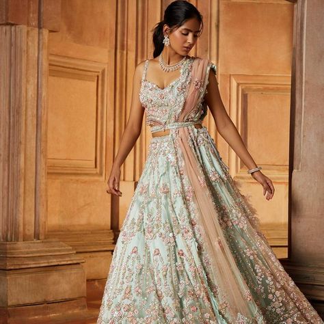 Nitika Gujral shared a post on Instagram: "This contemporary soft mint green tulle Lehenga set paired with a worked belt and a blush pink dupatta embroidered in a baroque floral pattern in tonal and contrast beads, sequins and crystals has a youthful elan! ——— Jewellery: @shriramhariramjewellers Styling and creative direction: @ayeshaaminnigam Photographer: @hormisantonytharakan HMU: @makeupkomal @aamirkhan_hairstylist Videographer: @studio36 Models: @husnbano6 Assistant stylist: @... Sage Green And Pink Lehenga, Sage Green Indian Outfit, Sage Green Lengha, Pink And Green Lehenga, Crystal Lehenga, Sage Green Lehenga, Tulle Lehenga, Gaye Holud, Designing Clothes