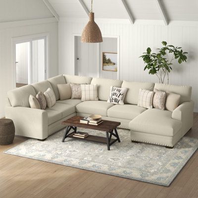This U-Shaped corner sectional seats up to five guests, so there's room for the whole family on game night. It includes three pieces: A sectional, sofa, and a chaise with a modular design that lets you tailor your living room to your liking. The frames are crafted from a blend of metal and solid and engineered wood, and they're wrapped in polyester with a beige hue. The foam and synthetic fiber-filled cushions give you just the right amount of support. A nailhead trim rounds out its look. Plus, Sectional Couch With Chairs Layout, Pillows For U Shaped Sectional, Sectional Couches Living Room, Beige Sectional Living Room Decor, Couch With Chaise Layout, Cream Sectional Living Room, Sectionals In Living Room, Living Room With Sectional, Best Sectional Sofa