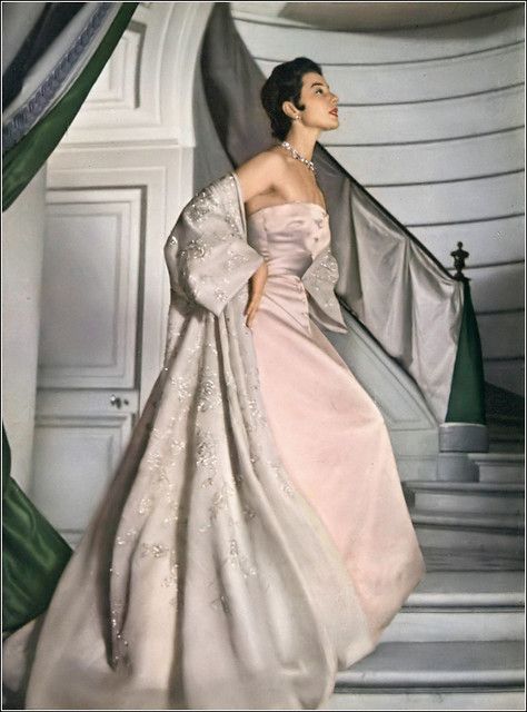 •Bettina Graziani in Christian Dior magnificent evening gown of pale pink Italian satin, over it a double silk organdy coat embroidered with paillettes •photo Henry Clarke in the hallway of Dior's new Paris house,  •Vogue, May 1953 Christian Dior Vintage 1950s Evening Gowns, 40s Evening Gown, Dior New Look 1950s, 60s Moodboard, Dior Moodboard, Bettina Graziani, Vintage Dior Gown, Christian Dior Aesthetic, Dior Gowns