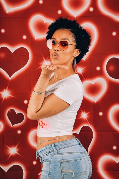 Photo of girl blowing a kiss in front of a red background with airbrush hearts. She is wearing fashion trends from the 1990s and 2000s. 2000 Heart Background Photoshoot, Throwback Valentines Day Photoshoot, Old School Backgrounds Photoshoot, 90s Heart Background Photoshoot, 2000s Heart Background Photoshoot, 2000s Valentines Photoshoot, 90s Valentines Day Photoshoot, Early 2000 Photoshoot, 90s Background Photoshoot