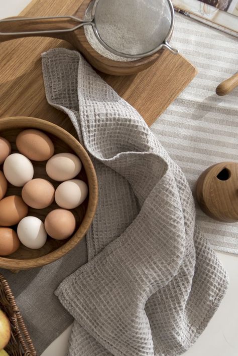 Table with kitchen tools, bowl of eggs and tea towel from waffle linen in oatmeal color. Organisation, Kitchen Towel Photography Ideas, Towel Shoot Ideas, Waffle Fabric Ideas, Tea Towel Photography, Kitchen Flat Lay, Kitchen Towel Gift Ideas, Towel Gift Ideas, Modern Kitchen Towels