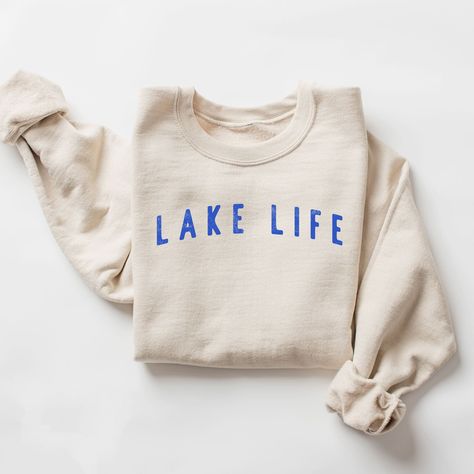 Our "Lake Life" sweatshirt is the epitome of cozy comfort, perfect for those who adore spending their leisure time by the tranquil shores of a lake. This sweatshirt is designed for both style and warmth, making it an essential addition to your summer night and cool-weather wardrobe. MATERIAL: Crafted from a blend of soft, high-quality cotton and polyester, this sweatshirt feels exceptionally comfortable against your skin. The interior is brushed for extra warmth and softness, making it perfect f Lake Apparel, Lake Outfits, Lake Clothes, Kids Christmas Sweaters, Lake Outfit, Lake House Gifts, Boat Lake, Lake Gifts, Summer Sweatshirt