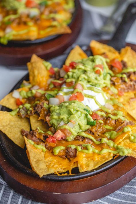 These restaurant style beef nachos are a great way to celebrate all trash fires in life: with chips, seasoned beef, cheese, and more, baked easily in cast iron or on a sheet pan in the oven. Top it with a spicy homemade green fire sauce. Fire Sauce, Beef Nachos, Oven Top, Pizza Roll, Nachos Beef, Dumpster Fire, Korean Dishes, Green Fire, Deilig Mat