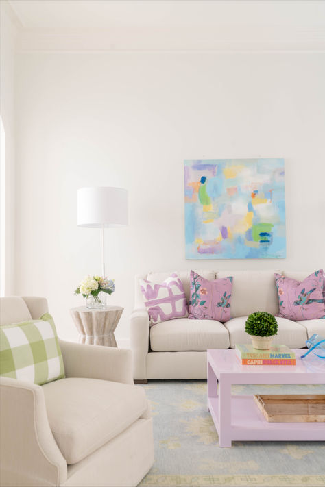 A small hint of color can help structure the space. We designed this family room with a custom coffee table to anchor down the color pallet. As soon as you walk in the first thing you see is lavender but softens when you look around. Blue Pastel Living Room, Living Room Pastel Colors Inspiration, Light And Colorful Living Room, White Couch Living Room Decor Colorful, Fun Color Living Room, Laura Park Living Room, Home Decor With Pops Of Color, Small Living Room Coffee Table, Small Apartment Aesthetic Living Room