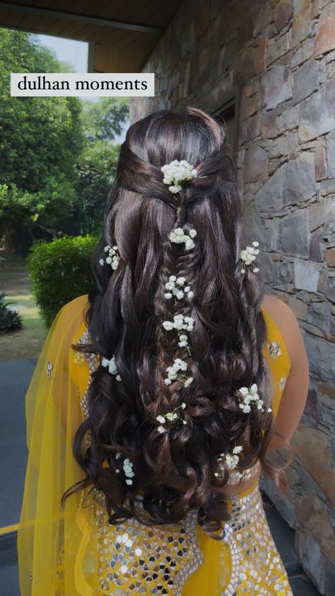 Mehendi bridal hairstyle with luscious curls and small braids with white flowers put beautifully Long Hair With Gajra, Punjabi Bride Hairstyle, Hairstyles For Jago Punjabi, Flower Braid Indian, Mayoun Hairstyles, Indian Hairstyles With Flowers, Long Braid With Flowers, Mehndi Braid, Kerala Wedding Hairstyle