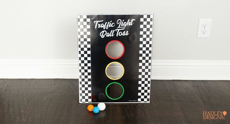 There's no need to reinvent the wheel. Take a new look at some classic games to make perfect DIY games and activities for your kid’s race car birthday. Instead of pin the tail on the donkey, there’s a printable pin the wheel on the car. Instead of regular-old ball toss, there’s a traffic light ball toss. There’s also a huge, race car track printable to color and play on. These are fun activities for any NASCAR, Formula 1, Hot Wheels, or Cars themed birthday party. Race Car Birthday Game Ideas, Racetrack Theme Party, Cars Themed Birthday Party Activities, 2 Fast Birthday Activities, Games For Race Car Party, Race Car Diy Decorations, Racing Birthday Party Games, Car Theme Birthday Activities, Race Car Theme Party Games
