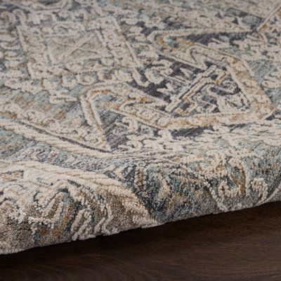 Boho style meets traditional flair in this versatile area rug. Taking inspiration from Persian rugs, it features a blend of gray and tan hues, which detail a central medallion design with botanical details and an intricate border. We love that a subtle distressed finish adds an antiqued vibe. It's power-loomed from polyester and polypropylene, and it shows off a 0.25" high-low pile height, so it's a great fit in high-traffic spaces where it won't trip up your feet or your vacuum. We recommend ad Charcoal Grey Rug, Nourison Rugs, Charcoal Rug, Medallion Pattern, Short Fringe, Artisan Rugs, Indoor Rug, Area Rug Collections, Custom Cushions