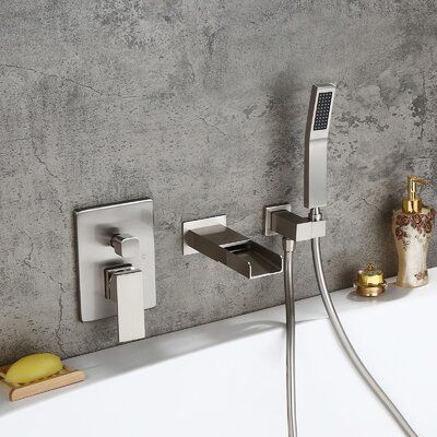 Homary Give a new dimension to your bathroom with this wall-mount waterfall tub faucet. With crisp edges and simple styling, this tub filler is the perfect interpretation of the sleek, modern design. Featuring a wide-open channel, it sends large water flow tranquillity down to fill the tub quickly while making a waterfall statement. Comes with a hand shower, it offers targeted cleaning over your body and gives you maximum flexibility and movement. Pretty and practical, this wall-mount tub filler Brass Bathtub Faucet, Brass Bathtub, Bathroom Tubs, Waterfall Bathtub Faucet, Waterfall Tub Faucet, Modern Waterfall, Bathtub Filler, Bathroom Tile Inspiration, Wall Mount Tub Faucet