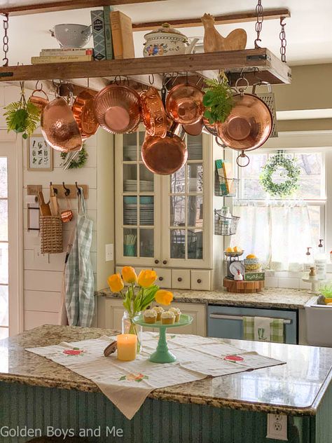 Farmhouse style kitchen with diy pot rack andspring decor - www.goldenboysandme.com Pot And Pan Ceiling Rack, Pot Rack Hanging Over Sink, Hanging Kitchen Rack, Kitchen With Pot Rack, Ceiling Rack Kitchen, Kitchen Pots Hanging, Kitchen With Pots Hanging, Kitchen Pot Rack Ideas, Pot And Pan Hanger Ceilings