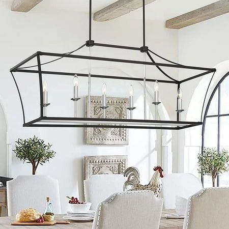 Take your dining ensemble from simple to stylish with this must-have chandelier. This minimalist silhouette has an open metal frame formed, offering six candle-style bulbs (not included) to place inside. Try hanging it over your dining room table, or suspend it above the kitchen island, it will emit a warm glow in your room. Two years warranty is included. Specifications: Style: Modern & Contemporary Material: Metal Finish: Classic Black+Chrome, Classic Black+Brass Dust Color: Classic Black+Chro Warm Minimalist Kitchen, Kitchen Chandelier Over Table, Farmhouse Lighting Dining, Metal Dining Room, French Country Dining, Kitchen Chandelier, Kitchen Island Linear Pendant, Farmhouse Light Fixtures, Light Kitchen Island