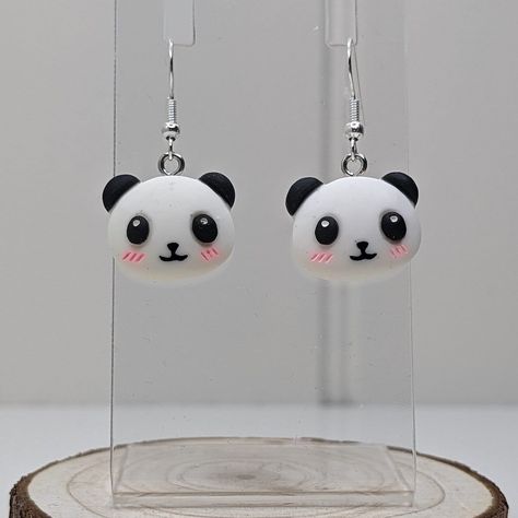 Whether a treat for yourself of a gift for a loved one, these cute kawaii panda earrings are the perfect statement earrings for expressing yourself.  The Earrings. These earrings are made of stainless steel and polymer clay. The measurements of these earrings are: Pendant Height: 1.6cm Pendant Width: 2cm Full Drop: 3.7cm Each pair of our earrings have been lovingly made and may vary slightly in colour, pattern and size to the displayed image. Dispatch and Delivery. Please allow 1-2 working days for your item/s to be dispatched. All items will be posted in letterbox friendly packaging with free second class postage to UK mainland (England, Scotland, Wales and Northern Ireland) addresses only. If you have any questions please do message and we would be more that happy to help in assisting yo Kawaii, Clay Panda, Panda Earrings, Expressing Yourself, Affordable Earrings, Earrings Kawaii, Kawaii Panda, Quirky Earrings, Earrings Designs