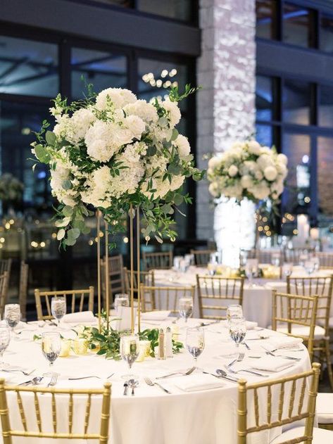 Mar 10, 2021 - Tall floral centerpieces for wedding reception on gold stands. White And Gold Winter Wedding, Centerpieces For Wedding Reception, Tall Floral Centerpieces, Tall Flower Centerpieces, Gold Wedding Centerpieces, Centerpieces For Wedding, Reception Table Centerpieces, White Floral Centerpieces, White Wedding Decorations