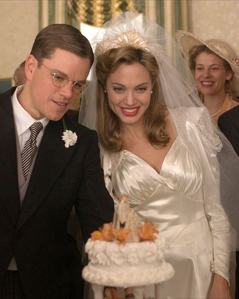 Costume designer Ann Roth dressed Angelina Jolie in an art deco-inspired wedding dress for her role as Margaret "Clover" Russell in the 2006 picture. The cream satin dress, vintage curls, and of course, bold lip, were all fitting for the film set in the 1930s. The Good Shepherd Movie, Cream Satin Dress, John Voight, Movie Wedding Dresses, Iconic Wedding Dresses, Movie Wedding, Wedding Dress Costume, Tv Weddings, 1930s Wedding