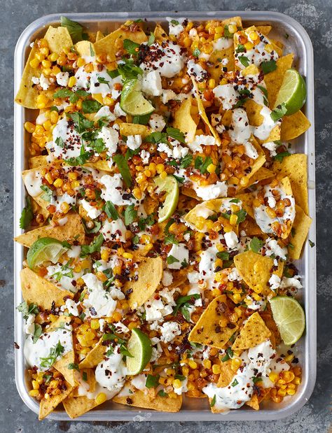 Perfect for a party, our sweetcorn nachos recipe is fresher, lighter and based on elote - a Mexican grilled corn street food. Suitable for veggies and just 20 minutes from start to finish, gather your friends round and dive in! Mexican Night Recipes, Mexican Night Ideas, Mexican Night Party, Mexican Food Vegetarian, Street Party Food, Mexican Food Night, Mexican Party Ideas, Corn Nachos, Mexican Dinner Party