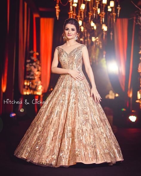 Stealing hearts in that shimmering gold gown and minimal accessories! #gowns #bride #bridetobe #jewellery #mettalics Engagment Dress, Indian Engagement Outfit, Wedding Reception Gowns, Latest Wedding Gowns, Engagement Dress For Bride, Engagement Gown, Bride Reception Dresses, Bridal Trousseau, Party Dresses With Sleeves