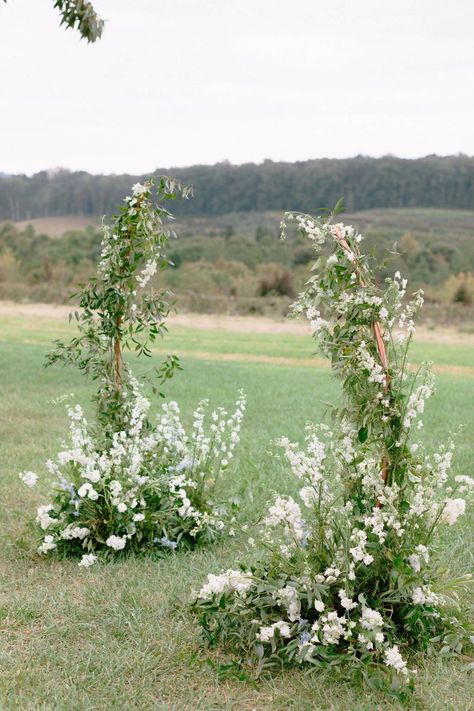 This classic ceremony backdrop floral arrangement was designed with your classic ivory palette but with hints of blue giving it whimsical feel! Visit our blog to see more pictures. Ceremony Flower Backdrop, Whimsical Ceremony Arch, Wedding Garden Backdrop, Arch For Outdoor Wedding, Small Ceremony Decor, Simple Alter Decorations, Ceremony Flowers Altar Outdoor, Outdoor Summer Wedding Ceremony, Whimsical Wedding Arbor