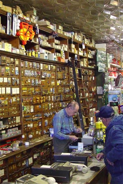 Could be the old Howland Hardware Store in my town....same shelves, same counter, same ladder! Hobby Store Design, Small Town Hardware Store, Old Hardware Store, Hardware Store Aesthetic, Vintage Hardware Store, Vintage General Store, Mercantile Store, Old General Stores, Sliding Ladder