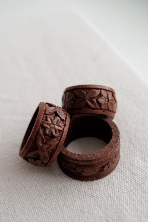 Our vintage hand carved Lena Napkin Rings make a timeless statement. These earthy wooden napkin rings are carved with floral motifs. Due to the hand carved design each napkin ring is one of a kind, motifs will vary slightly between each napkin ring. Sold as a set of 6.Works with our artisan made Mojave Napkins.Origin: IndiaManufacturing: Hand carvedMaterial: WoodColor: BrownCondition: Good. Vintage. Wear and inconsistencies are unique to the original item.Dimensions: 1.00” H x 2.00” DiaRecommend Slow Roads, Wooden Napkin Rings, Home Goods Store, Studio Home, Ceramic Rings, Carved Designs, Napkin Ring, Wood Rings, Wooden Rings