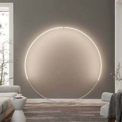 Experience the awe-inspiring beauty of minimalist design with our oversized, brilliantly luminous circular LED floor lamp—a true centrepiece for any space. Crafted from durable metal with a sleek metallic finish, this lamp is crowned by an aluminium and acrylic diffuser. However, its standout feature lies in its gracefully curved and delicately slim silhouette. Perfect for positioning behind a sofa, along a foyer wall, or even in the master bedroom, it exudes an ultra-modern vibe. This circular Led Circle Light, Front House Lighting Ideas Modern, Minimalist Lamp Bedroom, Minimalist Bedroom Design Ideas, Podcast Decor, Arch Lighting, Designer Floor Lamp, Curved Floor Lamp, Home Yoga Room