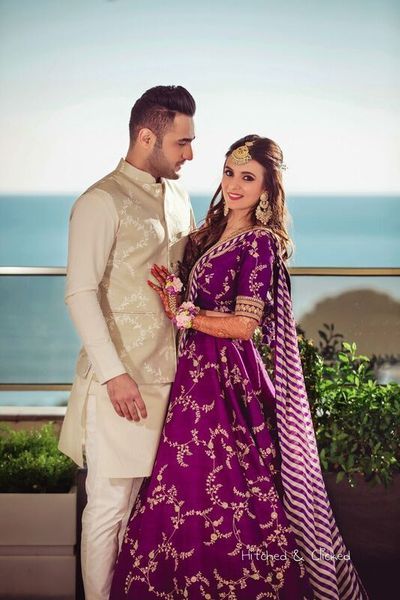 Mehendi portrait in purple Sabyasachi lehenga Wedding Album, Sabyasachi Lehenga Bridal, Sabyasachi Bridal, Sabyasachi Bride, Couple Wedding Dress, Wedding Lehenga Designs, Wedding Albums, Engagement Outfits, Groom Outfit