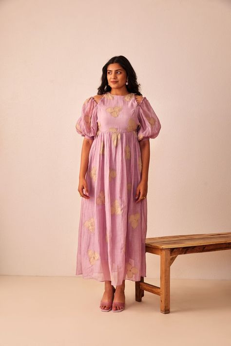 Zhuzh up your summer look in this delightful lavender foliage dress. Featuring a floral applique work, the dress is designed a yoke with gathers at the waist and sleeve allows you to flow with the spring breeze. The flair makes it sure to be a perfect dress for a nice day out with your friends. Chanderi Frock Designs, Hand Designs For Frocks, Printed Kurti Designs Style Floral, Simple Cotton Frocks For Women, Frock Models For Women, Cotton Frocks For Women, Salwar Ideas, Long Frocks For Women, Stiching Ideas