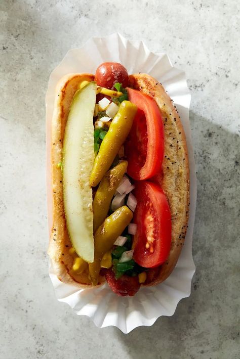 A proper Chicago dog is an all-beef frankfurter (such as Vienna Beef) in a poppy seed bun, topped with yellow mustard, neon-green sweet pickle relish, chopped white onion, tomato slices, a dill pickle spear, pickled sport peppers, & celery salt. If you can’t find Chicago-style sport peppers, then sliced pepperoncini works in a pinch. Don’t skip the celery salt; its herbal lightness makes these dogs shine. And don't even think of putting ketchup on it 😁 Chicago Style Hot Dogs, Italian Beef Sandwiches Chicago, Burger Ideas, Hot Dog Restaurants, American Chinese Food, Sweet Pickle Relish, Chicago Style Hot Dog, Dog Restaurant, Desserts Drinks