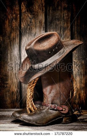 American West rodeo cowboy dirty and used black felt hat atop worn and old leather working rancher boots with vintage spurs and ranching rope in an antique ranch barn - stock photo Old Cowboy Boots, Arte Cowboy, Cowboy Photography, Cow Boys, Chapeau Cowboy, Western Photography, Cowboy Rodeo, Wilde Westen, Vintage Cowboy Boots