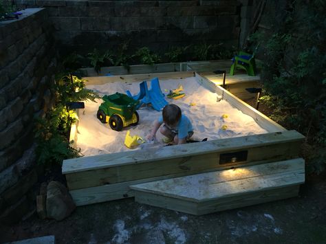 Custom sandbox, with storage and mini-deck, LED lighting. Requires 44 50lb bags of sand. Sandbox portion is 6' x 8'... Built in 2 days on the weekend. In Ground Sandbox Ideas, Diy Wooden Sandbox With Lid, Built In Sandbox Sand Pit, Sand Box With Lid, Outdoor Sandbox Ideas Easy Diy, Big Sandbox Ideas, Sand Box Ideas Backyards, Sandbox Toy Storage Ideas, Large Sandbox Ideas