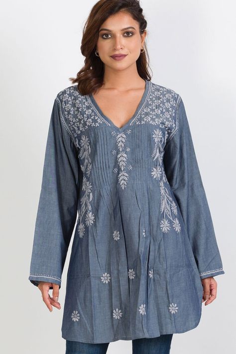 "Our Divya Chambray Tunic is hand embroidered by women artisans in Northern India in the shadow-work style known as \"Chikankari\". Chikankari is a delicate and artfully done hand embroidery that women in this region have been doing for generations. The chambray cotton fabric has a soft steel blue and silver weave, adding a rich and elegant texture that enhances the exquisite hand embroidery of this tunic. With a comfortable, elegant cut, this tunic is a contemporary twist on the classic Indian kurti. Color: Denim & Silver." Fresco, Denim Kurti, Hand Embroidered Tunics, Pretty Kimonos, Elegant Texture, Embroidered Cotton Top, Indian Kurti, Chambray Tunic, Fair Trade Clothing